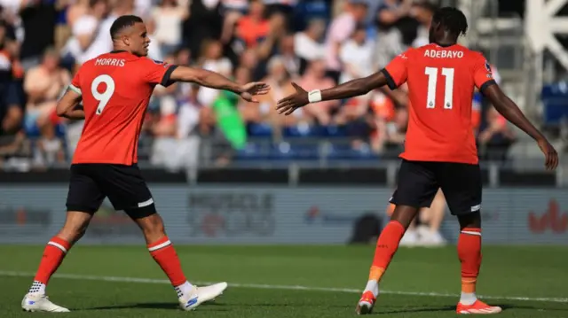 Carlton Morris and Elijah Adebayo reach out for a high five