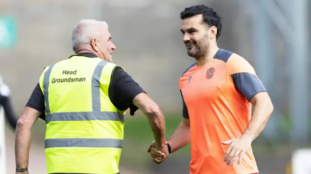 Tony Watt shakes hands with the St Johnstone groundsman