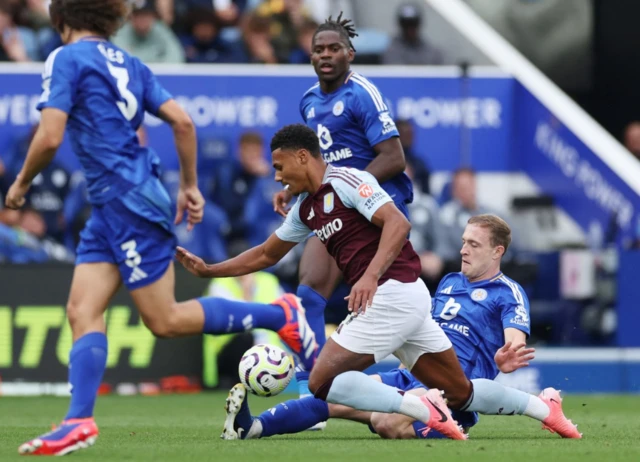 Oliver Skipp in action with Aston Villa's Ollie Watkins