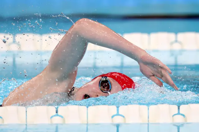 Poppy Maskill in the heat of the race with her right arm curving up above her head