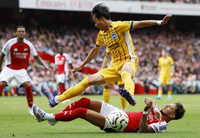 Ben White in action with Brighton & Hove Albion's Kaoru Mitoma