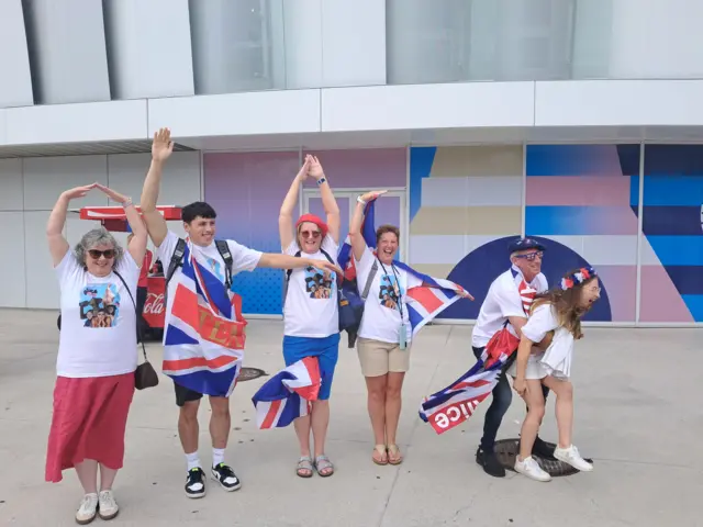 Alice Tai's friends and family pose for a photograph to spell out 'Alice'