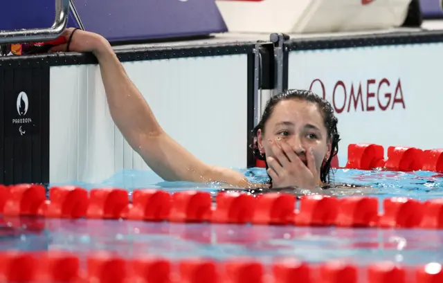 Alice Tai covers her mouth in disbelief after winning gold