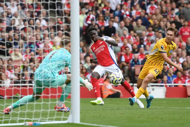 Bukayo Saka of Arsenal has a shot saved by Bart Verbruggen