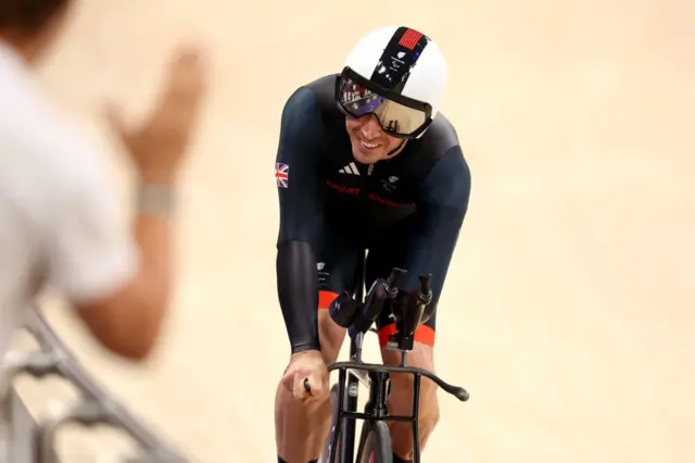 van Gass smiles at the crowd on his bike