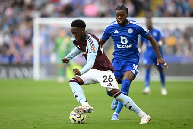 Lamare Bogarde of Aston Villa runs with the ball under pressure from Stephy Mavididi