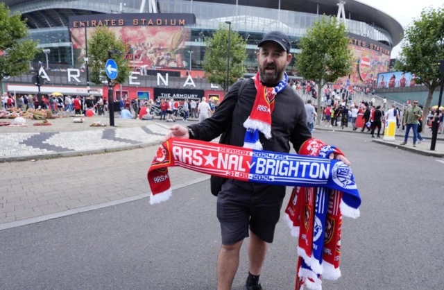 A street vendor selling half and half scarves