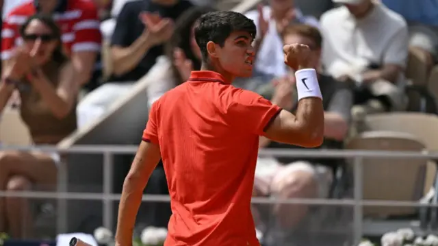 Spain's Carlos Alcaraz reacts while playing against Serbia's Novak Djokovic during their men's singles final tennis match on Court Philippe-Chatrier at the Roland-Garros Stadium