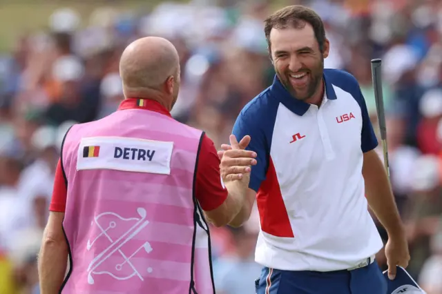 Scheffler celebrates his win with his caddy