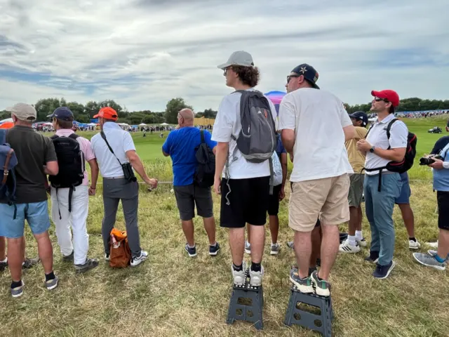 Fans use stools to watch Tommy Fleetwood