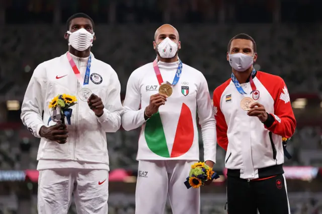 Silver medalist Fred Kerley of Team USA, gold medalist Lamont Marcell Jacobs of Team Italy and bronze medalist Andre De Grasse of Team Canada