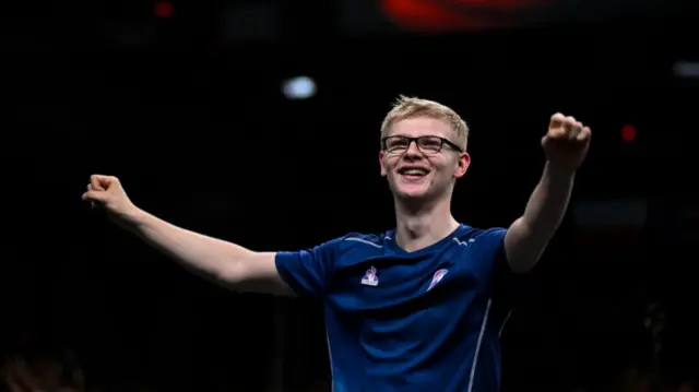 France's Felix Lebrun (C) reacts after winning his men's table tennis singles bronze medal match against Brazil's Hugo Calderano