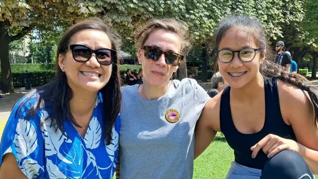 Three women pose for a photo