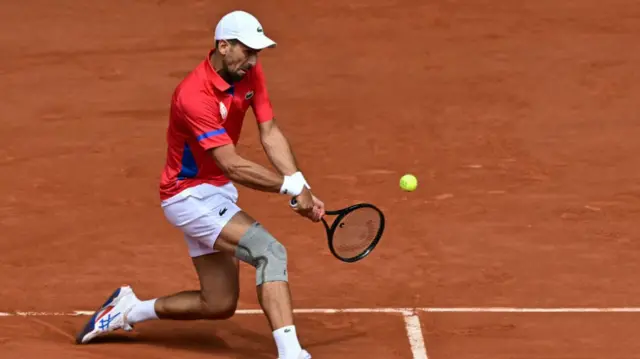 Serbia's Novak Djokovic returns to Spain's Carlos Alcaraz during their men's singles final tennis match on Court Philippe-Chatrier at the Roland-Garros Stadium during the Paris 2024 Olympic Games