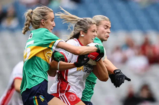 Aoibhinn McHugh is tackled by Áine Redican and Kasey Bruen