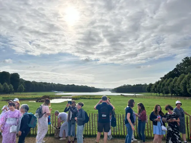 Fans take photos of the Palace of Versailles