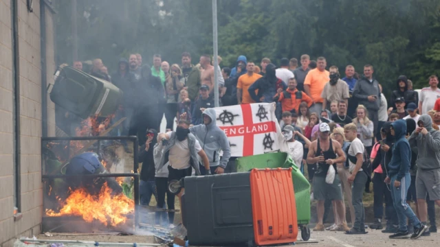 A group of demonstrators next to a fire