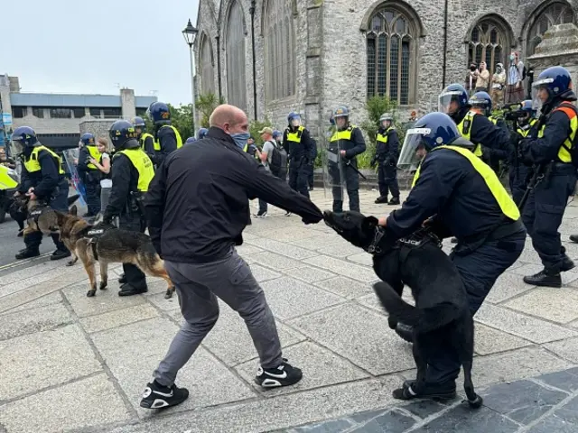 A dog bites a protester in Plymouth