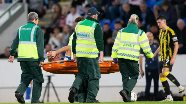 Sam McClelland stretchered off