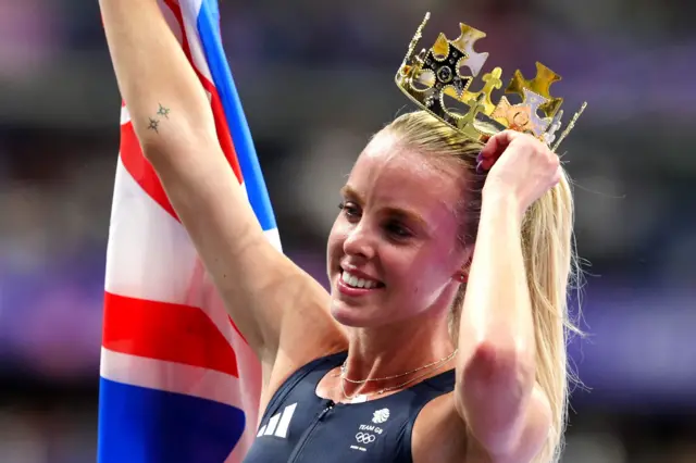 Hodgkinson holds a crown above her head