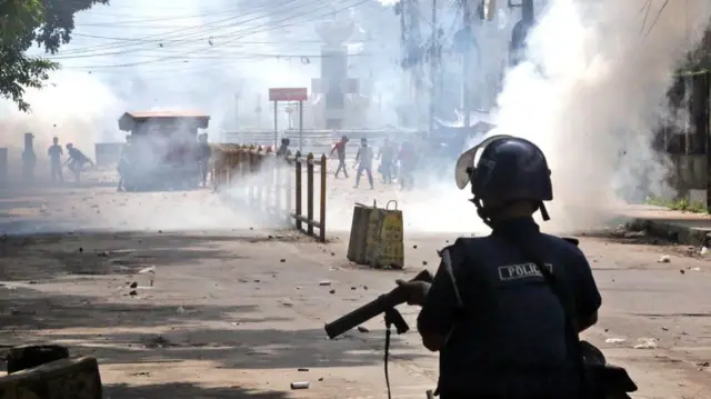 Police use tear gas to disperse protesters in Bangladesh on Sunday.