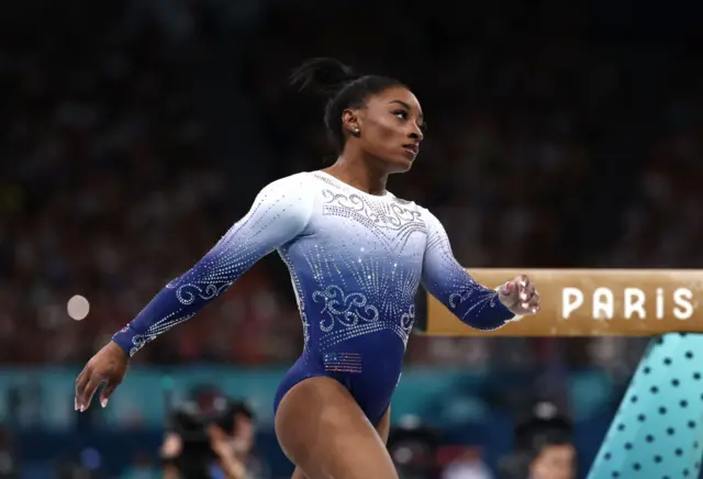 Simone Biles looking unhappy after falling off the beam