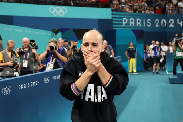 Alice D'Amato cries as she wins gold on the beam