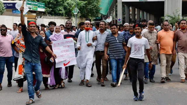 Protesters march on the street demanding the stepping down of Bangladeshi Prime Minister Sheikh Hasina in Dhaka.