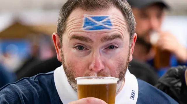 Scotland fan drinking beer