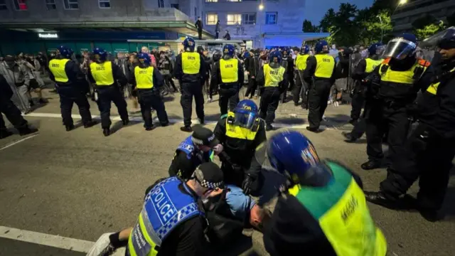 Riot police detain man in Plymouth