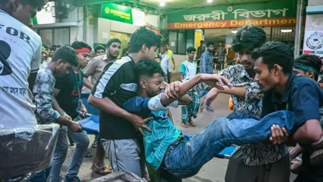 n injured protester is being brought for treatment at Dhaka Medical College Hospital during a clash between police and protesters.