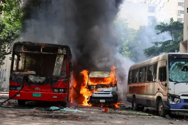 Protesters are setting a hospital car on fire during a rally