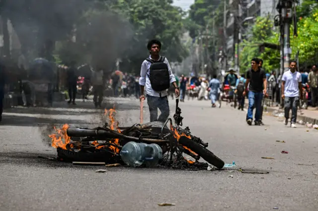 Protesters are burning a motorcycle and blocking the Shahbagh intersection during a protest in Dhaka, Bangladesh, on August 4, 2024