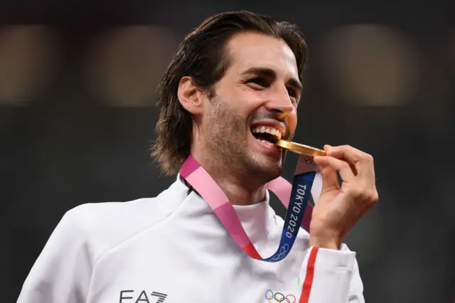 Gianmarco Tamberi bites his gold medal