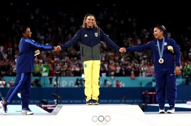 Simone Biles congratulates Rebeca Andrade following her gold medal in the women's floor final at the 2024 Paris Olympics