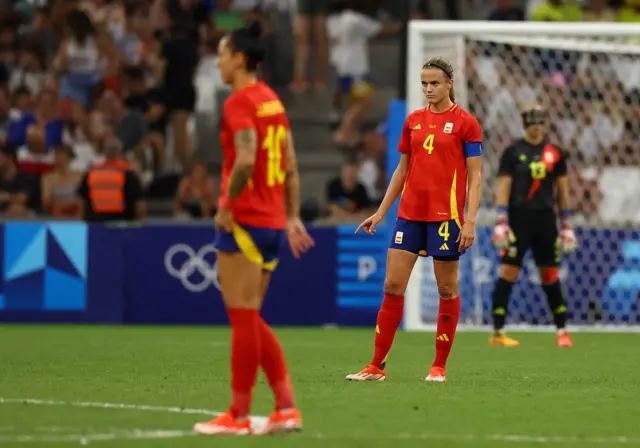 Paredes stands stunned after her own goal put Spain behind v Brazil