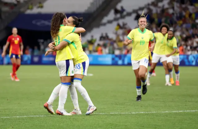 Portilho is mobbed after scoring Brazil's second goal v Spain