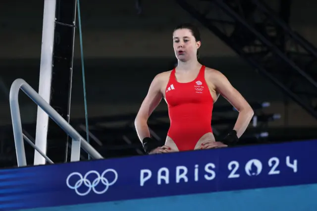 Sirieix prepares to dive off the ten metre platform, standing with hands on hips