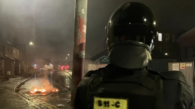 In Belfast a number of officers in riot gear sealed off a street and a number of fires were lit in the area