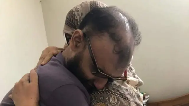 Ahmad Bin Quasem hugs a family member after his release.