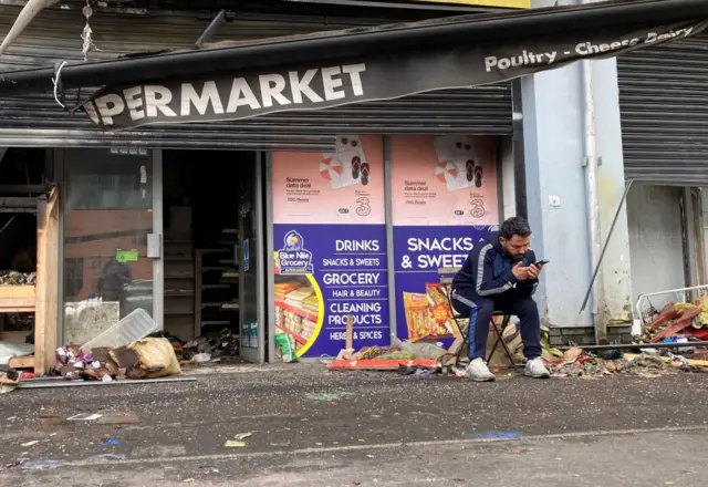 Abdelkader Mohamad Al Alloush, owner of the Sham Supermarket on Donegall Road in Belfast. The shop was burned during disorder in the area following an anti-immigration protest on Saturday.