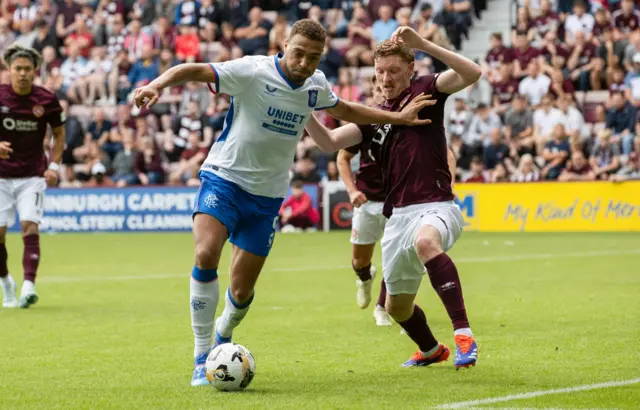 Cyriel Dessers battles with Hearts defender Kye Rowles