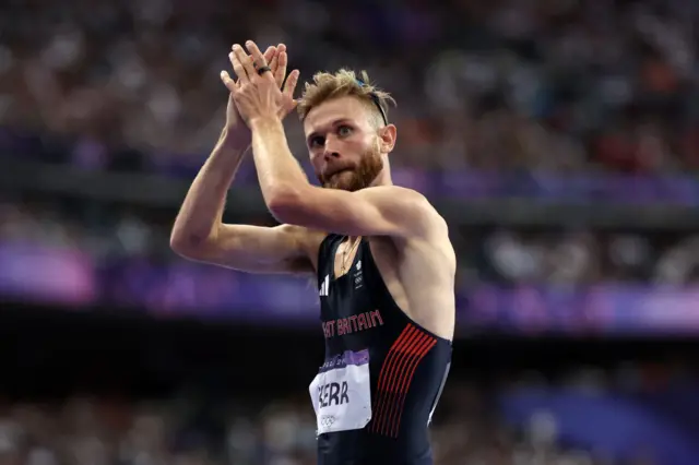 Josh Kerr claps the crowd after his 1500m semi-final run