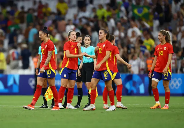 Spain players looks dejected after losing to Brazil