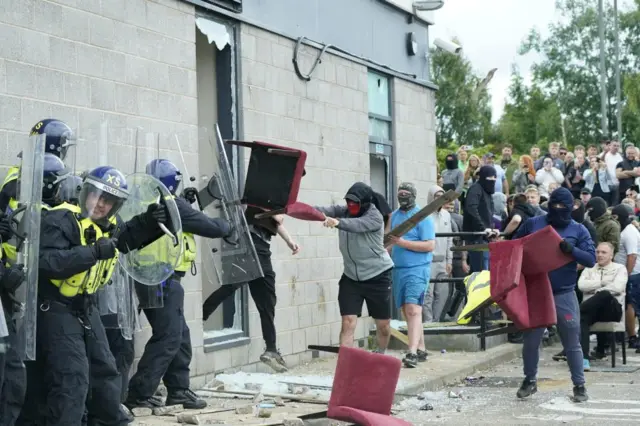 Protestors threw chairs at police officers during riots at the Holiday Inn Express in Rotherham on Sunday