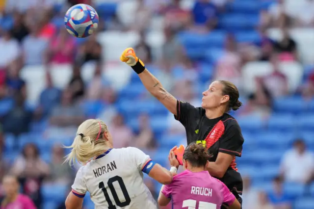 Berger punches a cross clear above a crowded box