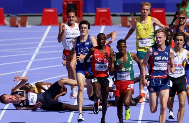 Narve Gilje Nordas of Norway and Hagos Gebrhiwet of Ethiopia in action before finishing first and second place in heat 1 as George Mills of Britain falls.