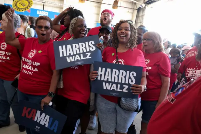 United Auto Workers (UAW) Local 862 auto workers pose for a picture while waiting for U.S. Vice President and Democratic presidential candidate Kamala Harris and her running mate Minnesota Governor Tim Walz to arrive at a campaign rally, in Romulus, Michigan, U.S., August 7, 2024.