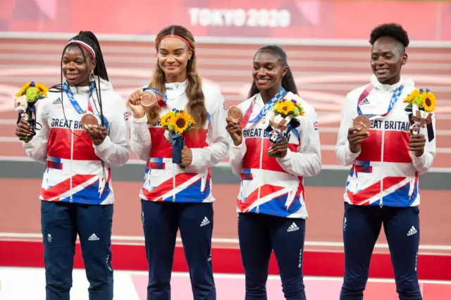 Asha Philip, Imani-Lara Lansiquot, Dina Asher-Smith and Daryll Neita of Great Britain with their bronze medals on the podium after the 4 x 100m relay at 2020 Tokyo Olympics