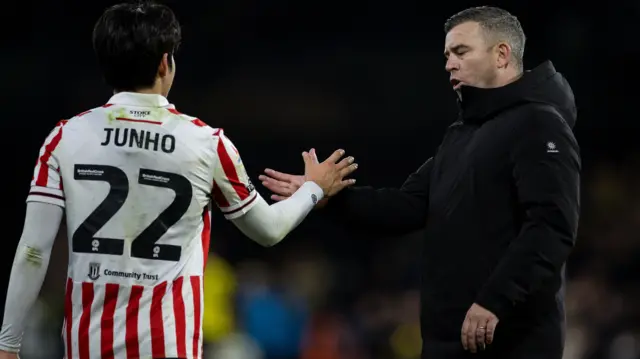 Bae Junho and Steven Schumacher shake hands